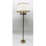 A REGENCY DESIGN EBONISED METAL AND BRASS STANDARD LAMP with triple branch top with fabric shade, on