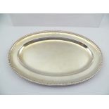 DANIEL SMITH & ROBERT SHARP A GEORGE III OVAL SILVER SERVING DISH with gadrooned rim, bears engraved