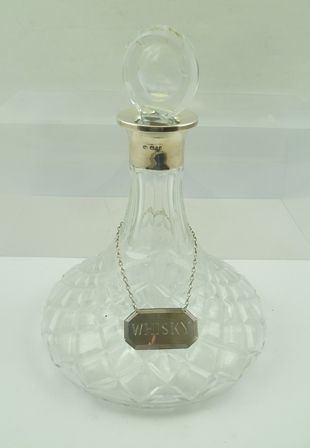 ISRAEL FREEMAN & SON LTD. A LATE 20TH CENTURY SILVER COLLARED CUT GLASS SHIP'S DECANTER with