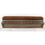 A POLISHED MAHOGANY INSTITUTIONAL WALL MOUNTING TWELVE SECTION MONEY BOX having twelve gilt numbered