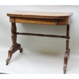 AN EARLY 19TH CENTURY SATINWOOD FOLD-OVER CARD TABLE, raised on shaped trestle end supports united