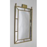 A REGENCY DESIGN GILT FRAMED WALL MIRROR with tablet crest with classical figure decoration, flanked