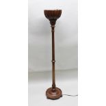 AN EDWARDIAN MAHOGANY UPLIGHTER, fluted carved bowl top with silvered reflector inside, raised on