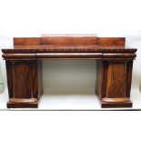 A 19TH CENTURY FIGURED MAHOGANY TWIN PEDESTAL SIDEBOARD, having gallery back with concealed drawers,