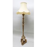 A GILDED STANDARD LAMP of Regency torchere design, having fluted stem on triform scroll supports