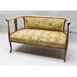 AN EDWARDIAN BEECH FRAMED TWO SEATER SALON SOFA having carved and pierced arm support splats, on