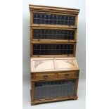 AN EDWARDIAN OAK BUREAU/BOOKCASE with Globe Wernicke design glazed sectional top, the base fitted