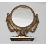 A ROCOCO DESIGN ORNATE GILT WOOD FRAMED DRESSING TABLE MIRROR, the circular plate floral framed,