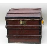 A VICTORIAN DOME TOP TRAVEL TRUNK of banded stained pine construction with metal reinforced edges