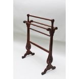 AN EDWARDIAN MAHOGANY TOWEL RAIL, having decoratively pierced trestle ends, 66cm wide