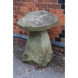 A STADDLE STONE AND CAP, height 84cm