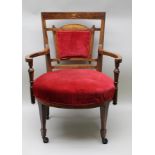 A LATE VICTORIAN ROSEWOOD OPEN ARM SALON CHAIR, having inlaid urn decoration to the crest rail,