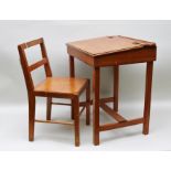 A MID-20TH CENTURY "TRIANG" STAINED WOOD CHILD'S DESK with hinged sloping lid and recess for