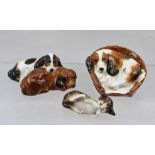 A ROYAL DOULTON CERAMIC COCKER SPANIEL, curled up in a basket, ref. HN2585, together with a ROYAL