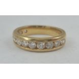 A LADY'S HALF ETERNITY RING set with twelve diamonds, the band marked 14k