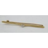 A 15CT GOLD BAR BROOCH set with a brilliant cut solitaire diamond