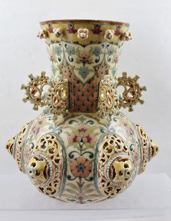 AN HUNGARIAN ZSOLNAY PECS POTTERY VASE, modelled and reticulated bulbous form, the neck with