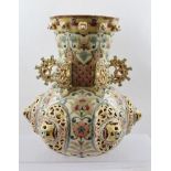 AN HUNGARIAN ZSOLNAY PECS POTTERY VASE, modelled and reticulated bulbous form, the neck with