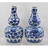 A PAIR OF CHINESE QING DYNASTY GOURD FORM PORCELAIN VASES, having cobalt blue painted floral