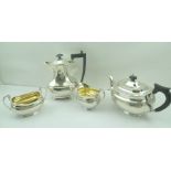 A MATCHED SILVER TEA SET of Georgian design, comprising teapot, milk jug, and a two-handled sugar