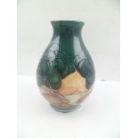 A MOORCROFT POTTERY VASE of squat baluster form, tube lined and glazed in "Mamoura" pattern,