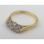 AN 18CT GOLD DIAMOND RING set three stones, the shank stamped 750