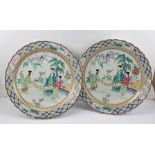 TWO CHINESE PORCELAIN CHARGERS in polychrome enamelling with scenes of a wise man with attendants