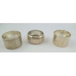 THREE SILVER NAPKIN RINGS, mixed hallmarks, total weight 65g.