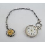 A SILVER FOB WATCH with white dial and chased case, with silver Niello Albert chain and a SILVER AND