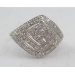 AN ART DECO STYLE 18CT WHITE GOLD RING set multiple diamonds in a curved diamond shape setting,