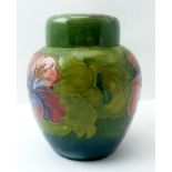 A MOORCROFT POTTERY GINGER JAR, of green ground, tube lined and painted with hibiscus pattern,