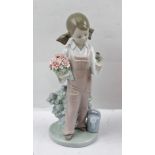 A LLADRO CHINA FIGURINE OF A GIRL with flowers and a bird, a watering can at her feet, printed and