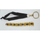 A VICTORIAN YELLOW METAL BRACELET, having seven oval links, set with cut and polished Lapis and