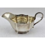 JOSIAH WILLIAMS & CO. A SILVER GRAVY BOAT of fluted Georgian design, raised on stepped base,