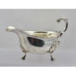 MAPPIN & WEBB A GEORGIAN DESIGN SILVER GRAVY BOAT, having acanthus leaf scroll handle, raised on