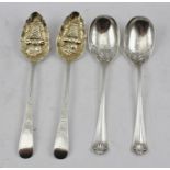 A PAIR OF GEORGE III SILVER BERRY SPOONS, having basket of fruit embossed bowls, remains of gilding,