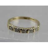 A 9CT GOLD LADY'S RING set with 20 small diamonds, size P