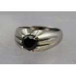 A GENT'S HEAVY 9CT. WHITE GOLD SOLITAIRE BLACK DIAMOND RING, considered to be 1.5ct in size, ring