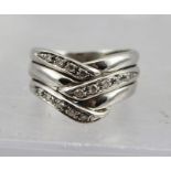 A HEAVY WHITE GOLD RING set with diamonds, considered to be 18ct, size N