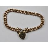 A 9CT ROSE GOLD CURB LINK BRACELET with padlock clasp, 21g.