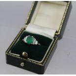 AN 18CT WHITE GOLD RING set with central emerald flanked by baguette cut diamonds, ring size "K", in