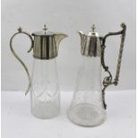 TWO CLARET JUGS with silver plated mounts, one has a cut glass body, the other engraved with