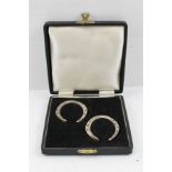 H. HUNT A PAIR OF MID 20TH CENTURY SILVER NAPKIN RINGS of horseshoe form, Sheffield 1949, 59g. in