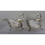 HAMPTON UTILITIES A PAIR OF MID 20TH CENTURY SILVER SAUCE BOATS of Georgian design, with acanthus