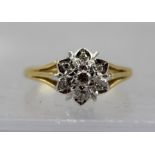 AN 18CT GOLD DIAMOND DAISY CLUSTER RING, size N 1/2