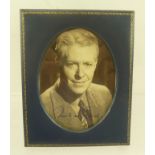 NELSON EDDY (1901-1967) A black and white studio portrait, autographed, oval mounted in easel