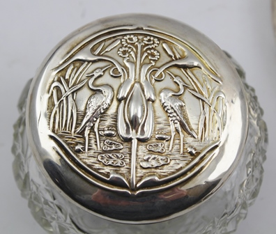 WILLIAM AITKEN AN ART NOUVEAU EMBOSSED SILVER HAND HELD VANITY MIRROR, the handle and surround - Image 2 of 6