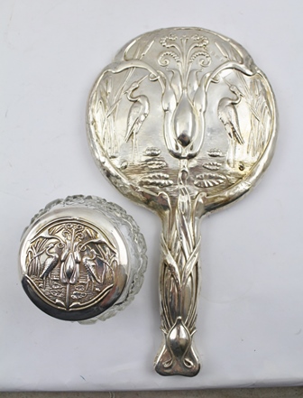 WILLIAM AITKEN AN ART NOUVEAU EMBOSSED SILVER HAND HELD VANITY MIRROR, the handle and surround