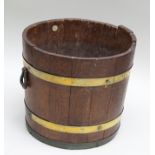 A "LISTER & CO. OF DURSLEY" OAK LOG CONTAINER, of barrel slatted form with brass bands and iron