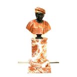 A 19TH CENTURY ROSSO ANTICO BUST OF MARCO POLO upon a veined rosso antico fluted column base, column